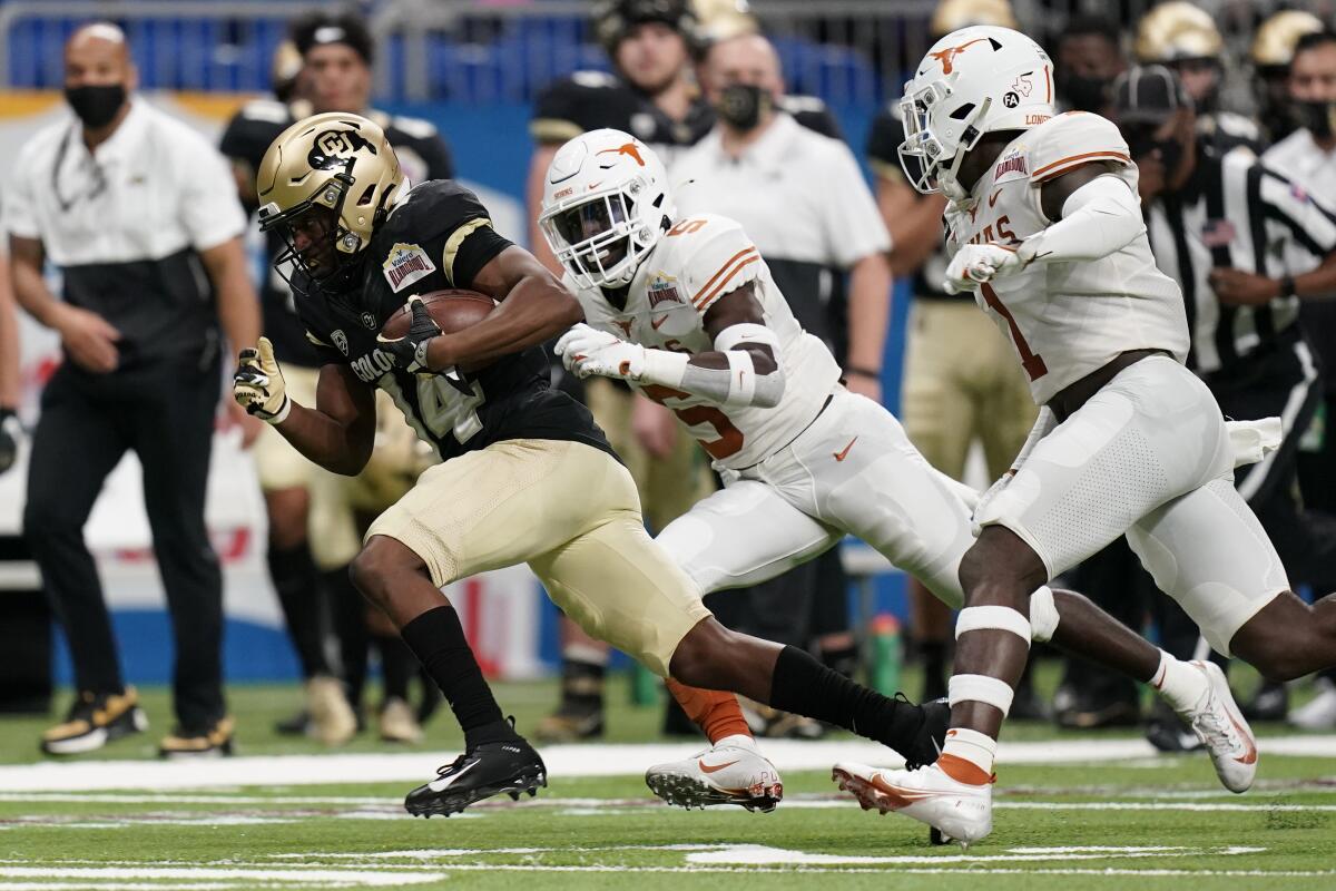 Colorado wide receiver Dimitri Stanley runs past Texas defensive back D'Shawn Jamison.