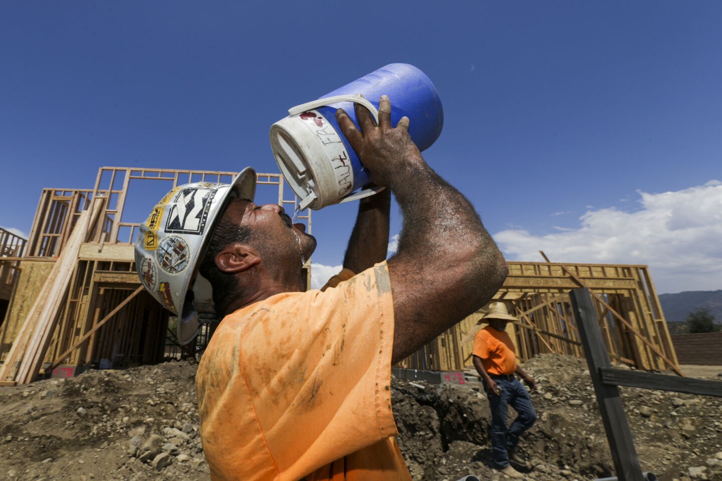 Reginaldo Ramirez gulps cold water after working in San Bernardino, which hit 111 degrees on Wednesday.
