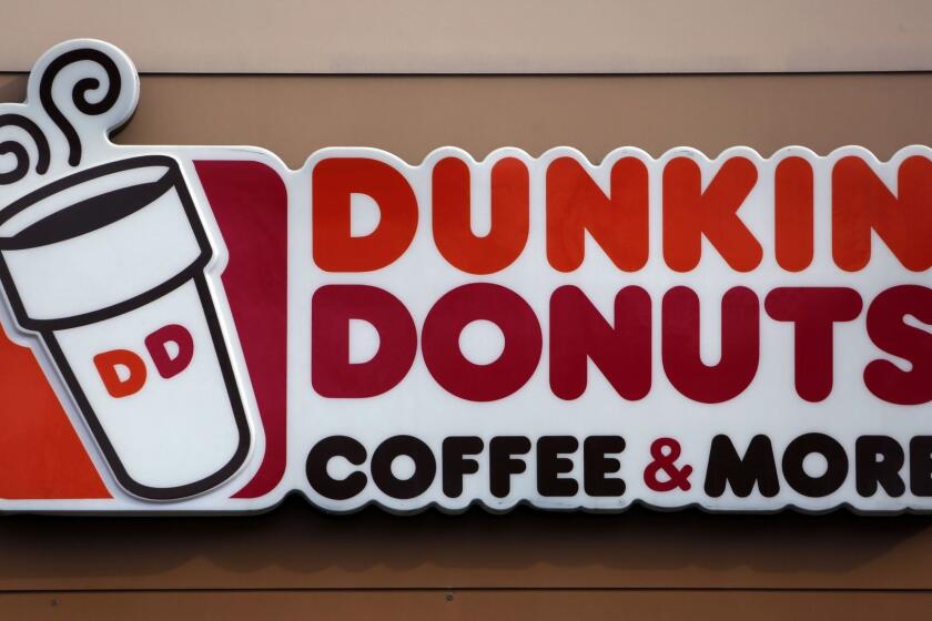 FILE- In this Jan. 22, 2018, file photo shows the Dunkin' Donuts logo on a shop in Mount Lebanon, Pa. Dunkin' is dropping the donuts â from its name, anyway. Doughnuts are still on the menu, but the company is renaming itself "Dunkin'" to reflect its increasing emphasis on coffee and other drinks. The change will officially take place in January 2019. (AP Photo/Gene J. Puskar, File)