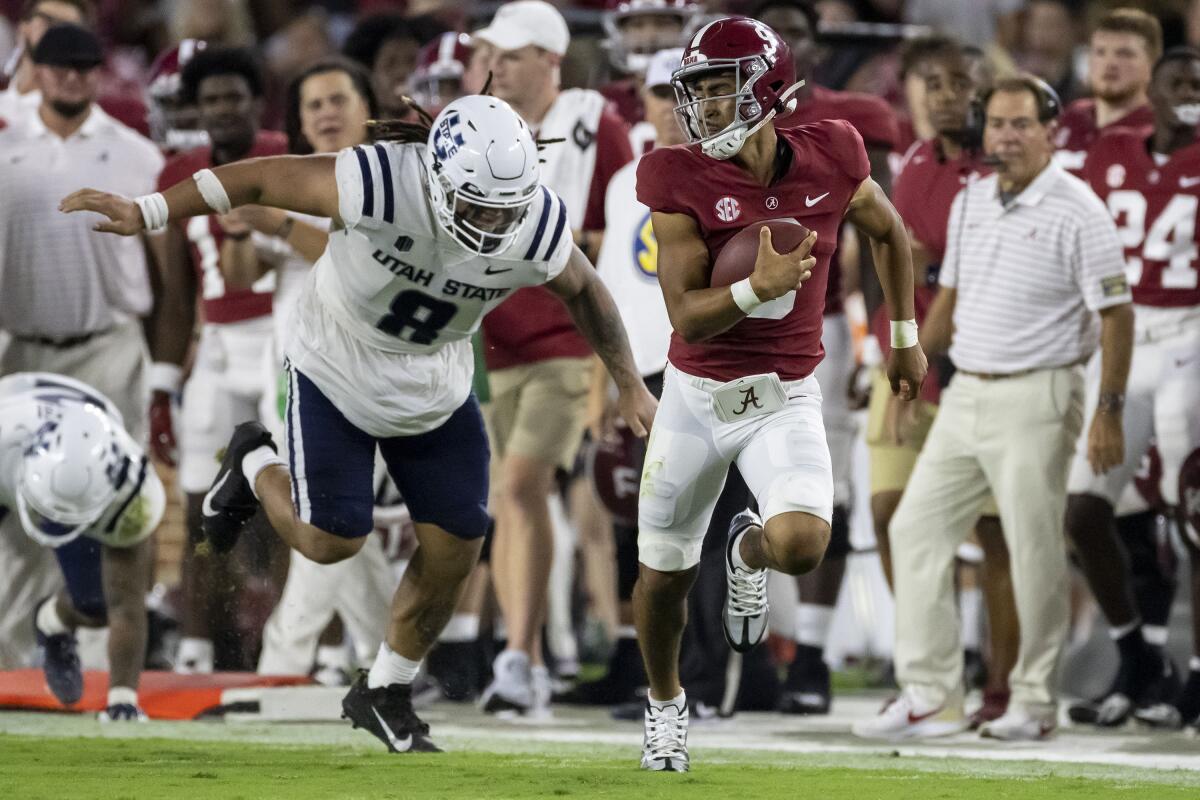 Alabama quarterback Bryce Young runs with the ball against Utah State on Sept. 3, 2022.