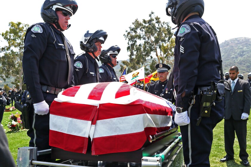 Pallbearers stand at the casket of Los Angeles Police motorcycle Officer Christopher Cortijo at burial ceremonies at Forest Lawn Holllywood Hills.