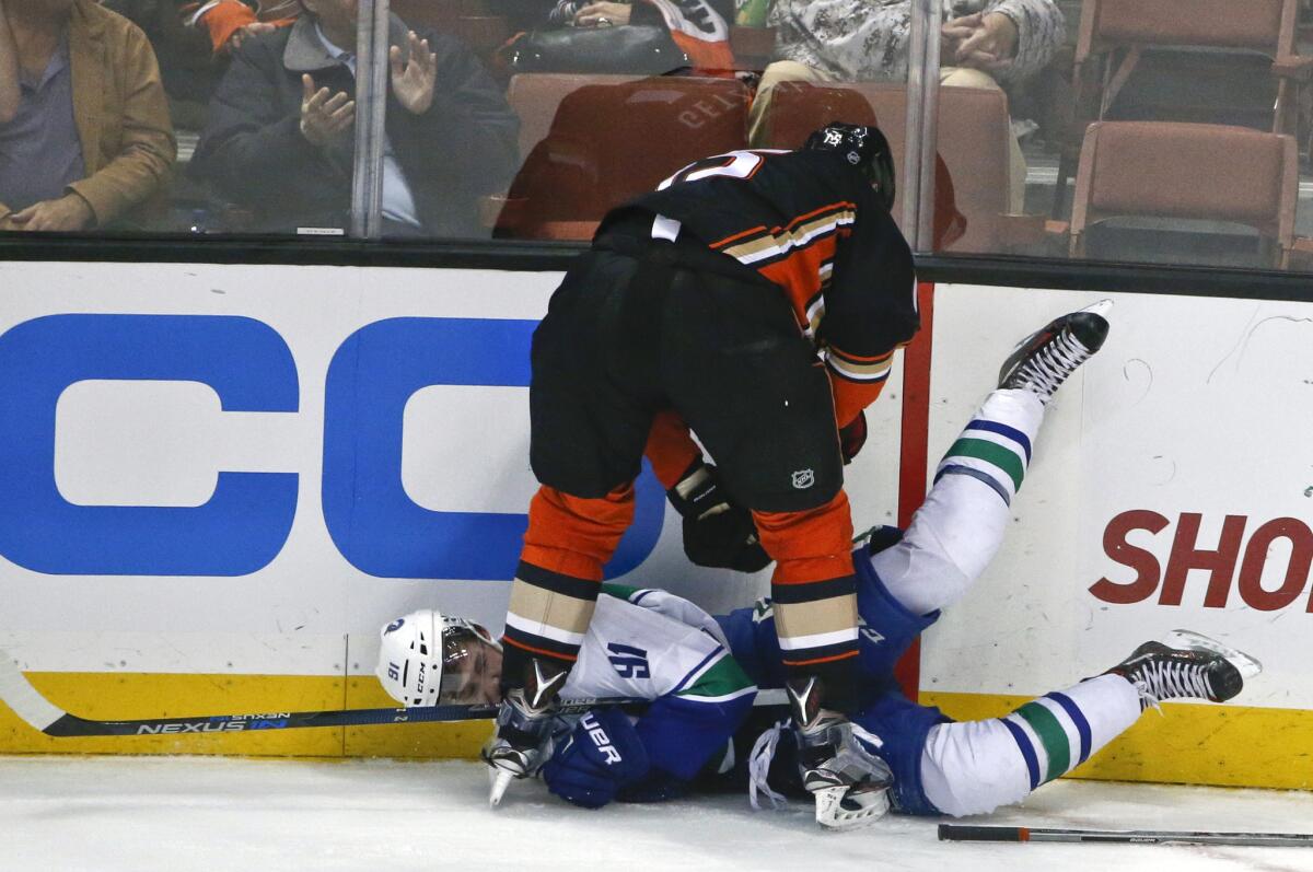 Ducks center Ryan Getzlaf stands over Canucks center Jared McCann during a confrontation in the third period.