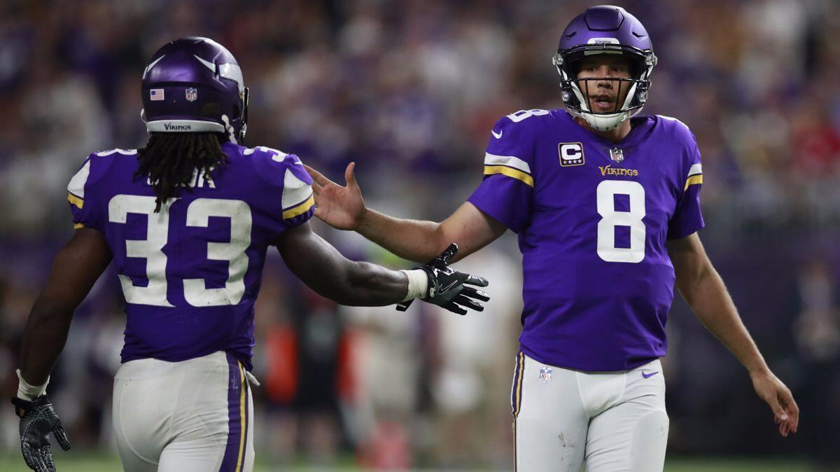 Minnesota Vikings running back Dalvin Cook (33) slaps hands with quarterback Sam Bradford (8) during a game against the New Orleans Saints on Sept. 11.