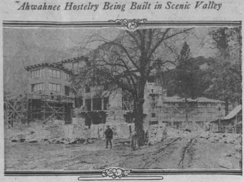 A clipping from an old newspaper shows a partially constructed multistory building, scaffolding and piles of lumber. 