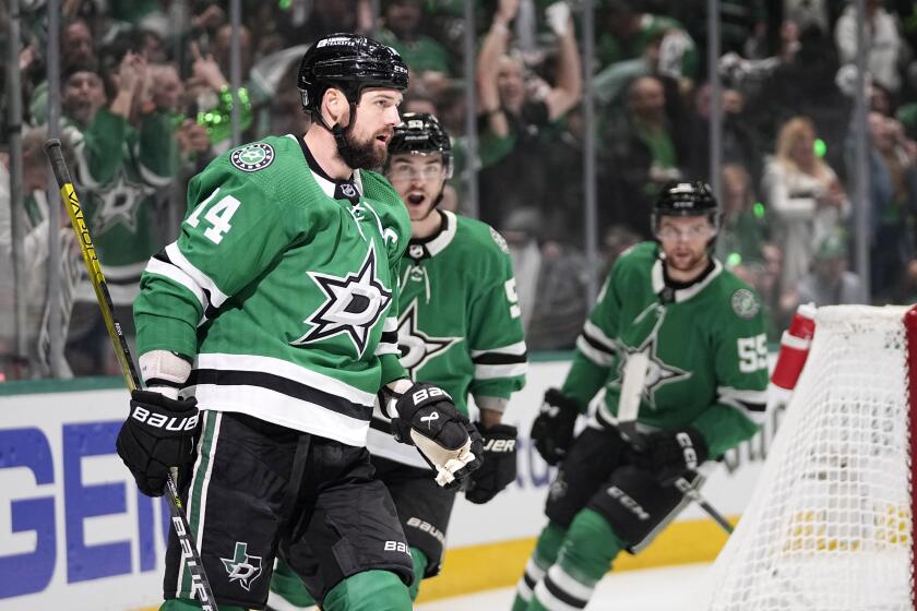 Dallas Stars left wing Jamie Benn (14), Wyatt Johnston, center, and Thomas Harley, right, celebrate after Benn scored during the first period in Game 2 of the Western Conference finals in the NHL hockey Stanley Cup playoffs against the Edmonton Oilers, Saturday, May 25, 2024, in Dallas. (AP Photo/Tony Gutierrez)