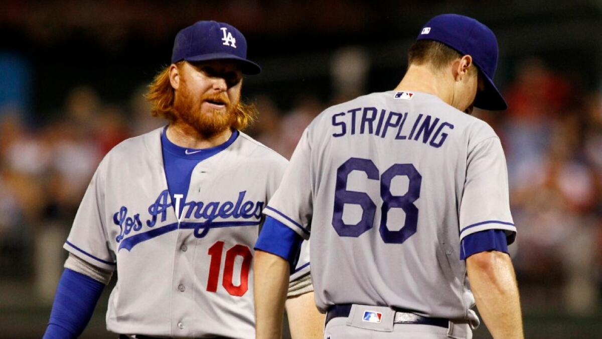 Dodgers third baseman Justin Turner talks with pitcher Ross Stripling during the fifth inning of a game on Aug. 18.