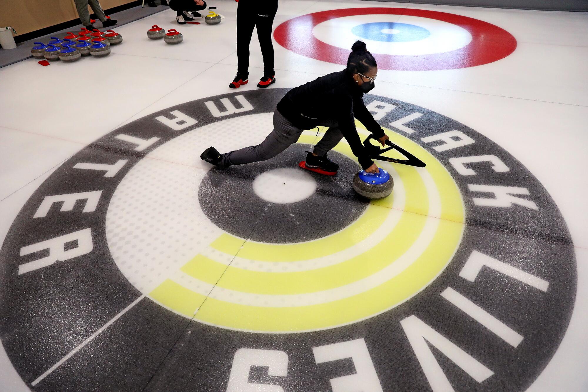 OAKLAND, CA - JUNE 10: Jocelyn Mapp, 31, of Castro Valley, learns how to deliver a curling stone.
