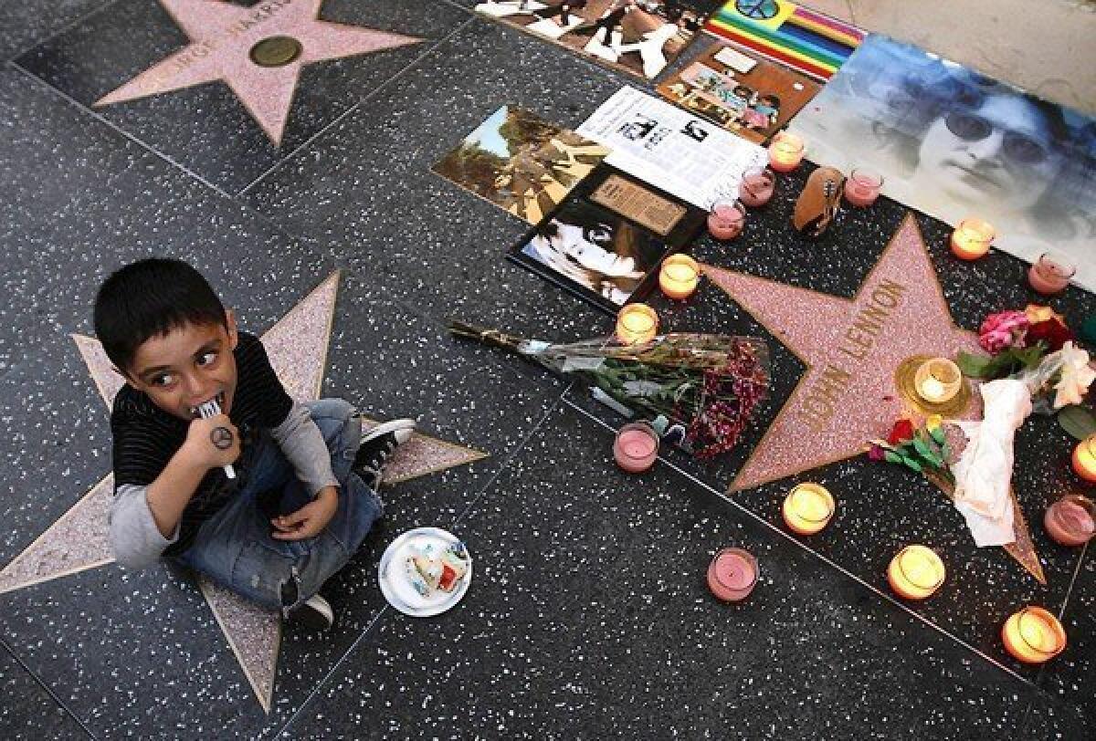 Lennon Lopez, 5, eats cake as dozens of fans gather at John Lennon's star on the Hollywood Walk of Fame on the singer's birthday.