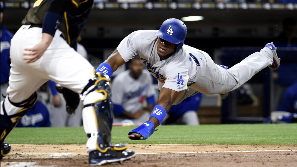 Dodgers right fielder Yasiel Puig scores against the Padres during a game May 20.