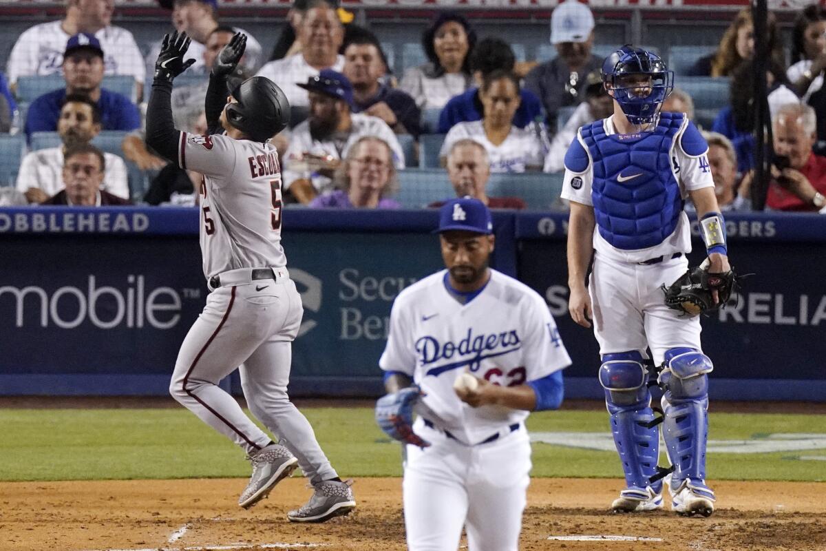 Arizona's Eduardo Escobar celebrates as he scores after hitting a two-run home run off Dodgers relief pitcher Darien Nunez.