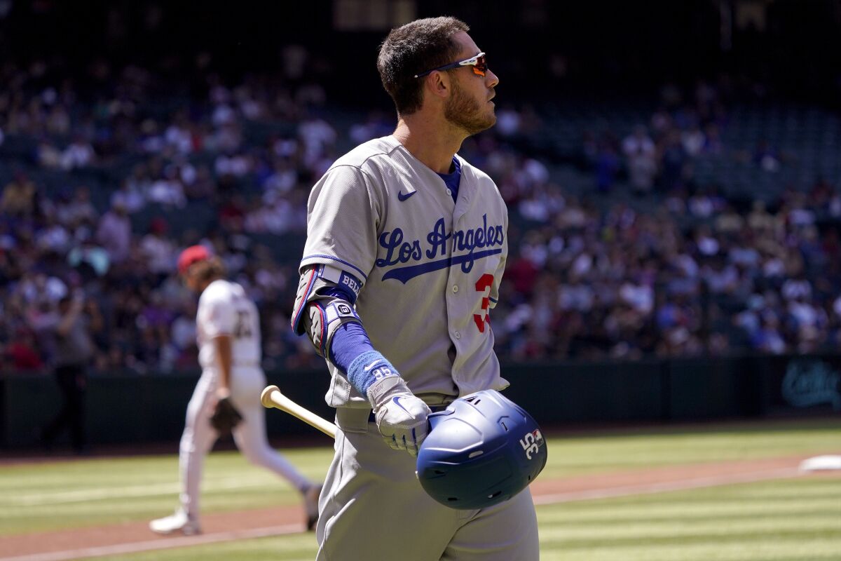 Dodgers center fielder Cody Bellinger walks to the dugout after striking out against the Arizona Diamondbacks.