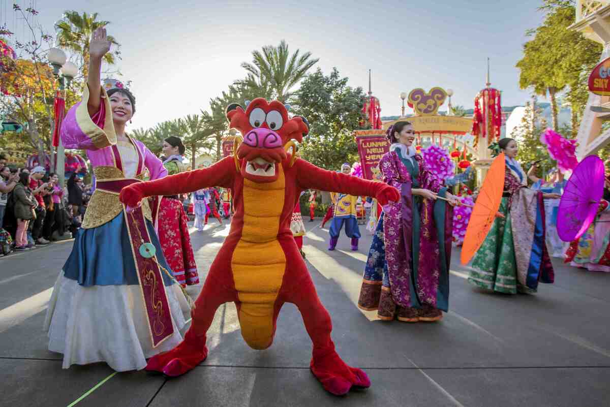 Dressed as Mushu, a Chinese dragon, a performer dances during celebration of the Lunar New Year at Disney California 