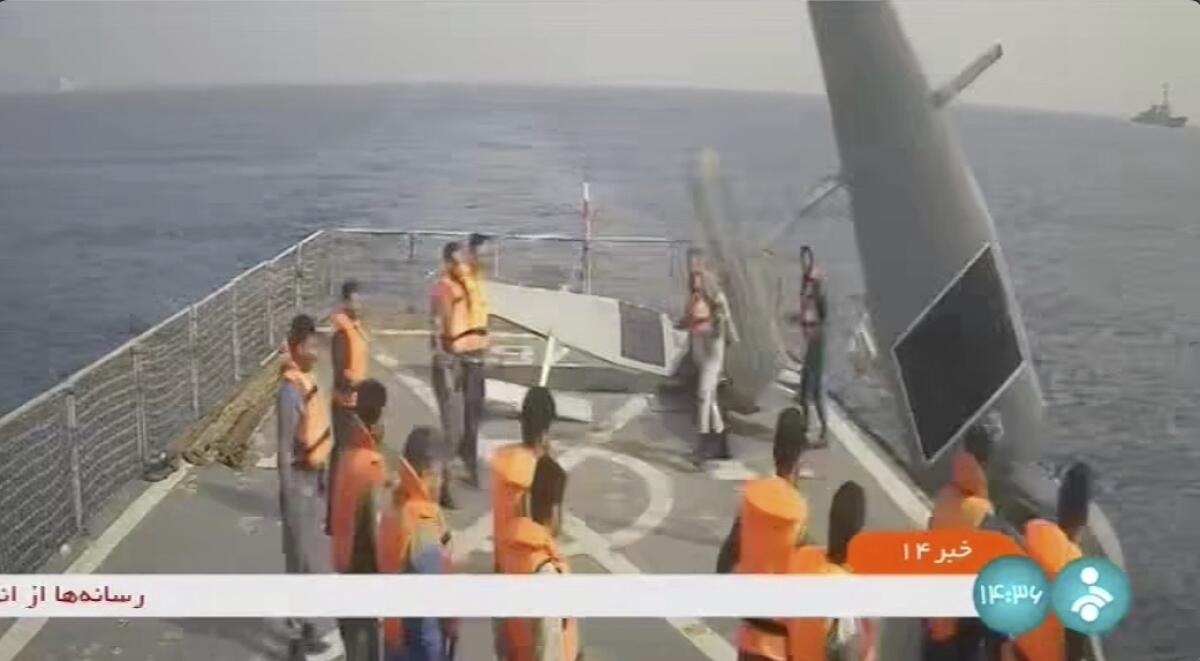 In this frame grab from Iranian state television, Iranian navy sailors throw an American sea drone overboard in the Red Sea on Thursday, Sept. 1, 2022. Iran said Friday its navy seized two American sea drones in the Red Sea before letting them go, the latest maritime incident involving the U.S. Navy's new drone fleet in the Mideast. Cmdr. Timothy Hawkins, a spokesman for the Navy's Mideast-based 5th Fleet, acknowledged the incident on Friday to The Associated Press but declined to immediately elaborate. (Iranian state television via AP)