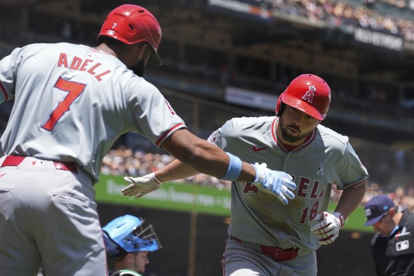 Los Angeles Angels' Nolan Schanuel, right, celebrates with Jo Adell after hitting a solo home run.