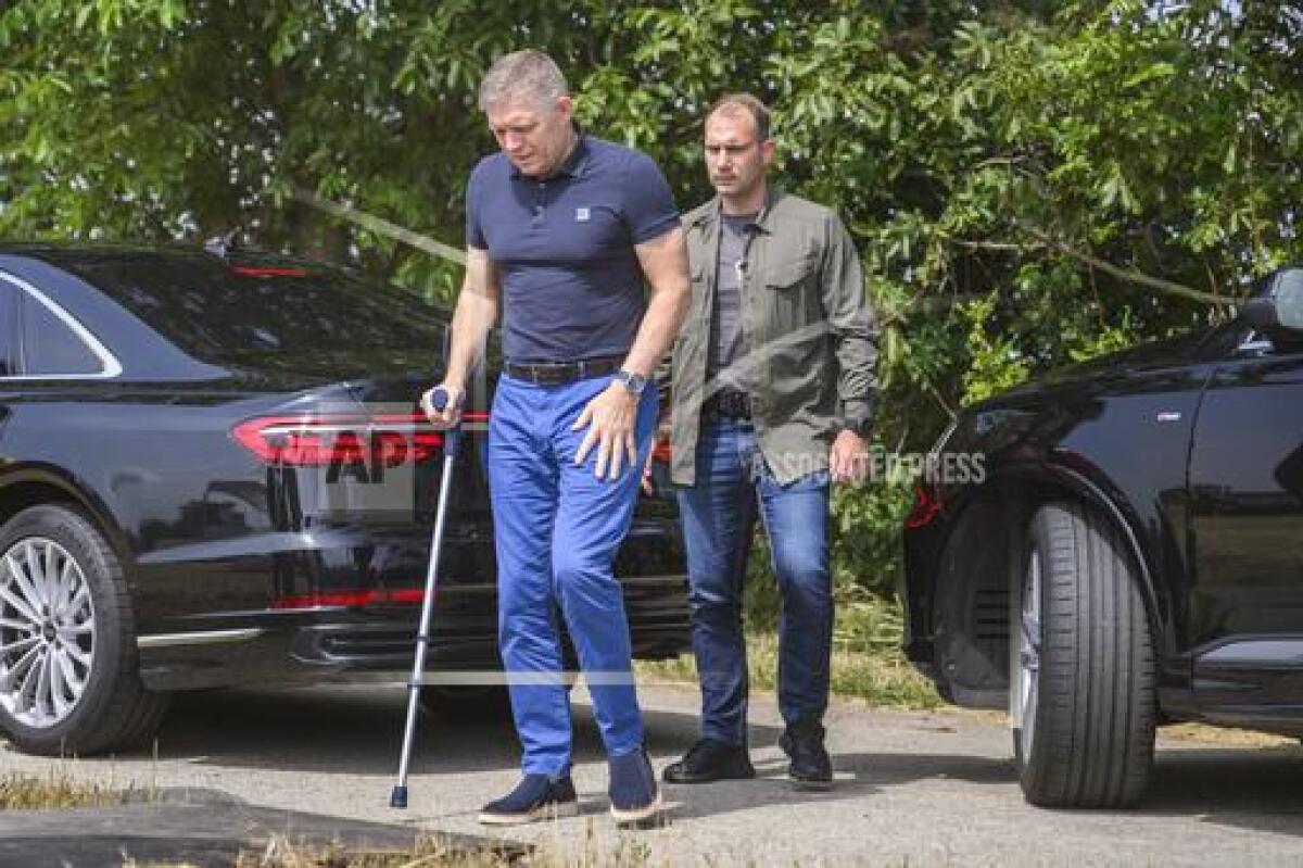 Slovak Prime Minister Robert Fico using a walking stick.