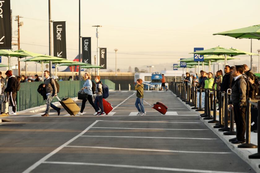 LOS ANGELES CA OCTOBER 29, 2019 — Passengers at LAX use the new passenger pickup lot Tuesday, October 29, 2019, the first day to connect with Uber, Lyft and taxis that are no longer allowed to pick up arriving passengers at terminals. (Al Seib / Los Angeles Times)
