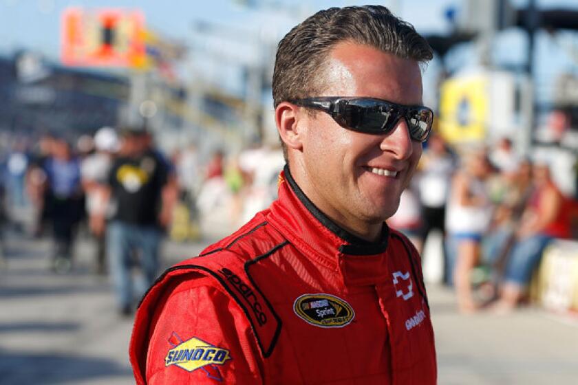NASCAR driver A.J. Allmendinger heads to his Sprint Cup car before the start of the Coke Zero 400 at Daytona International Speedway earlier this summer.