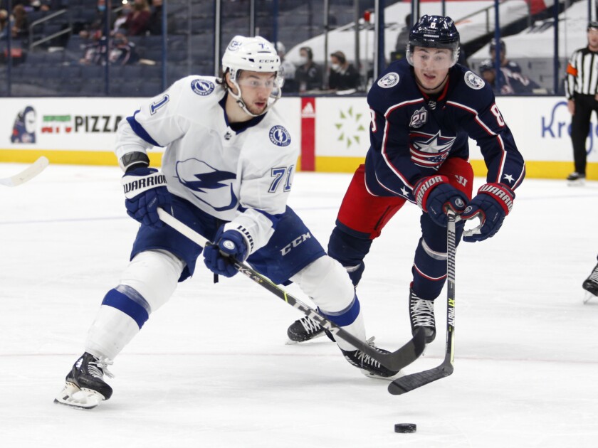Columbus Blue Jackets defenseman Zach Werenski, right, defends against Tampa Bay Lightning forward Anthony Cirelli during the third period of an NHL hockey game in Columbus, Ohio, Thursday, April 8, 2021. The Lightning won 6-4. (AP Photo/Paul Vernon)