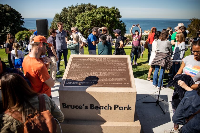 Manhattan Beach, CA - March 18: Residents and city leaders gathered to unveil a new monument that acknowledges and condemns the historical injustices of Bruce's Beach at 26th Street and Highland Avenue, in Manhattan Beach, CA, Saturday, March 18, 2023. Manhattan Beach Mayor Steve Napolitano personally apologized for the historical injustices and urged the city's Council to officially do the same. Some of the land making up Bruce's Beach was purchased by African American couple Willa and Charles Bruce, in 1912, establishing a resort that was open to African Americans. But by the 1920s, racial tensions grew in the beach community and the city condemned the properties. The park was renamed multiple times over the next 80 years and in 2007, was re-named for the Bruce family, responsible for trying to bring change and equality to the city. (Jay L. Clendenin / Los Angeles Times)