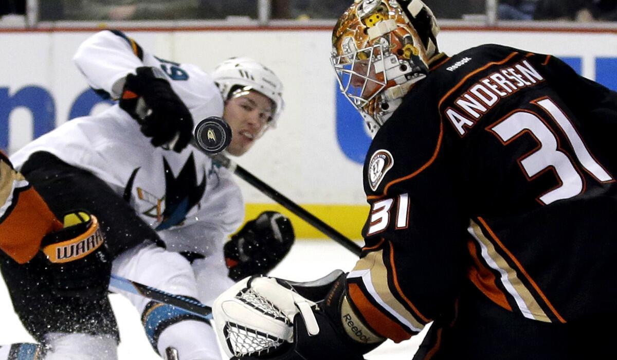 Ducks goalie Frederik Andersen bblocks a shot by Sharks center Joe Thornton in the first period.