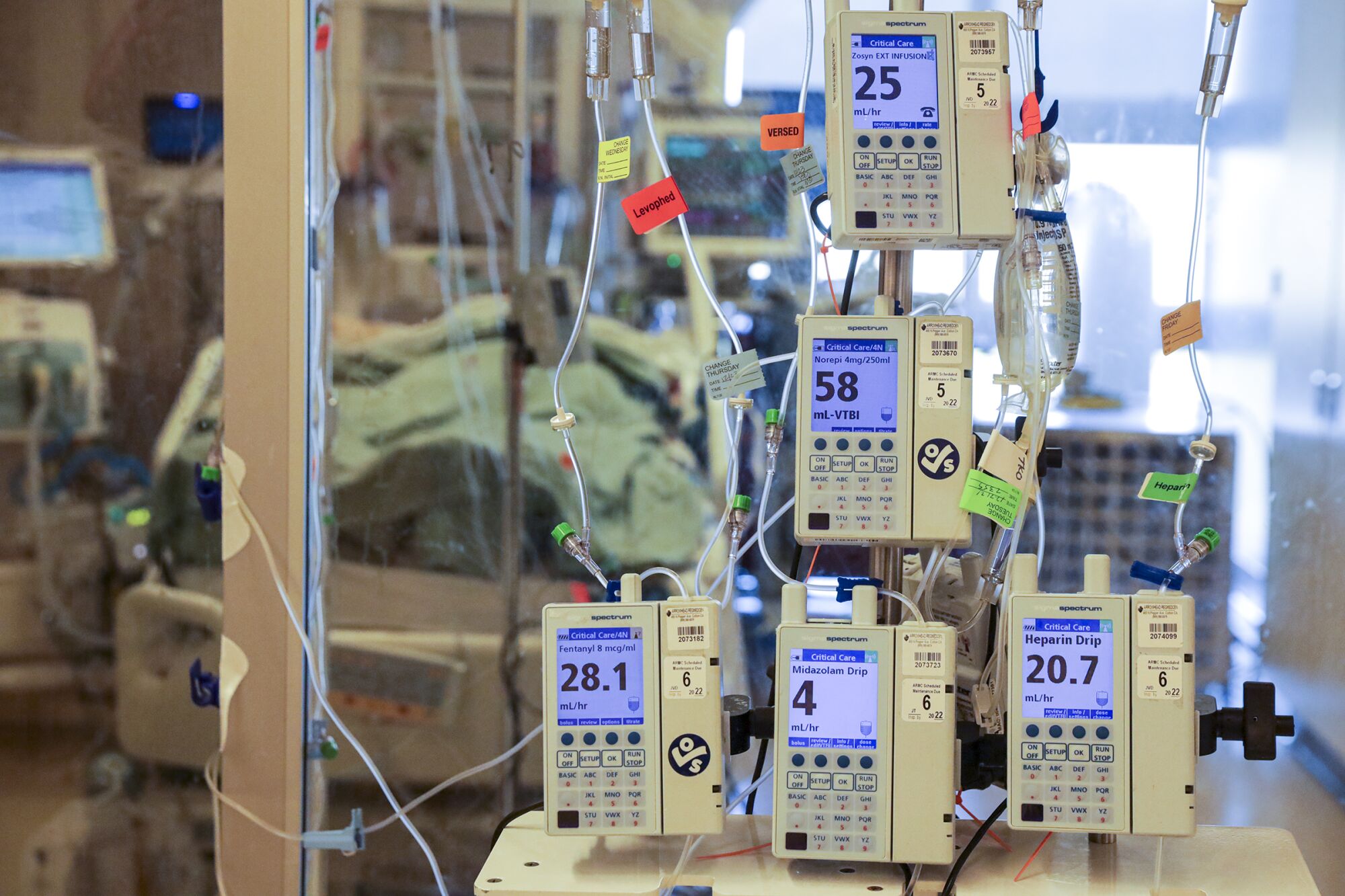 Intravenous pumps deliver medications to a COVID patient being treated in an ICU at Arrowhead Regional Medical Center.