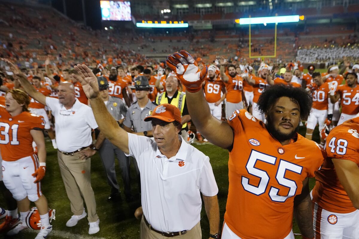Clemson coach Dabo Swinney and defensive tackle Payton Page (55) sing the school fight song Sept. 18, 2021.