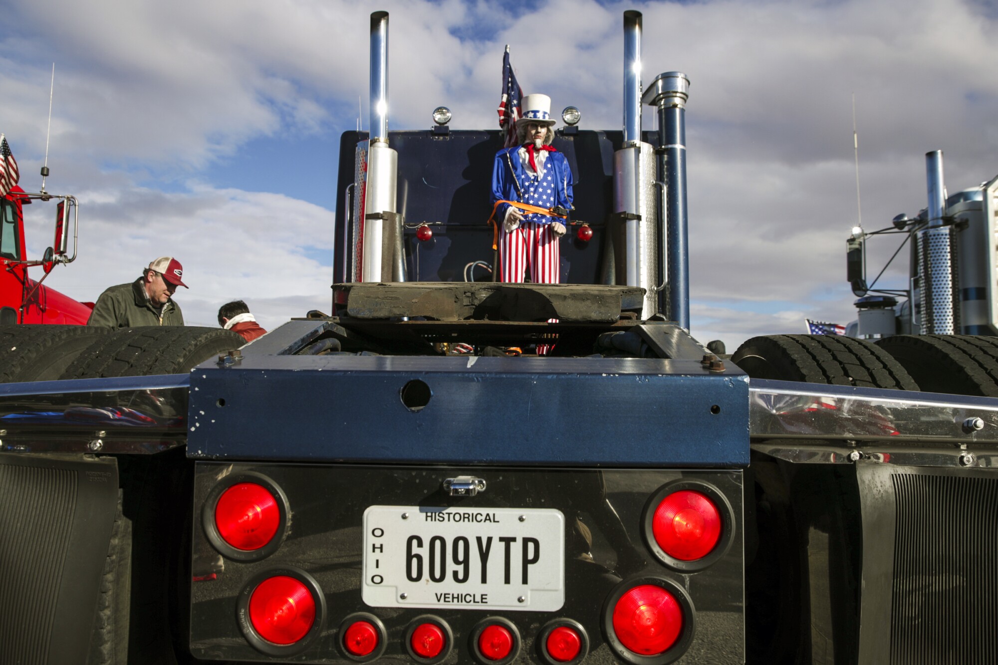 An Uncle Sam mannequin is strapped to a big rig