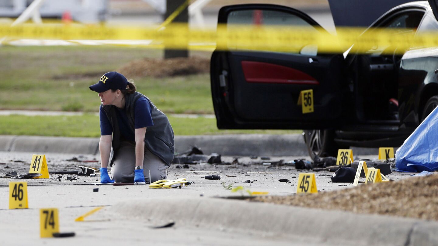 An FBI crime scene investigator works May 4 at the scene in Garland, Texas, where two gunmen were shot and killed after they opened fire on a security officer outside a provocative contest for cartoons of the prophet Muhammad.
