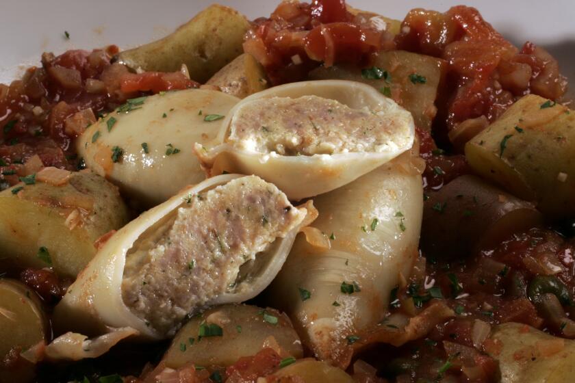 Sausage-stuffed squid braised with tomatoes and potatoes
