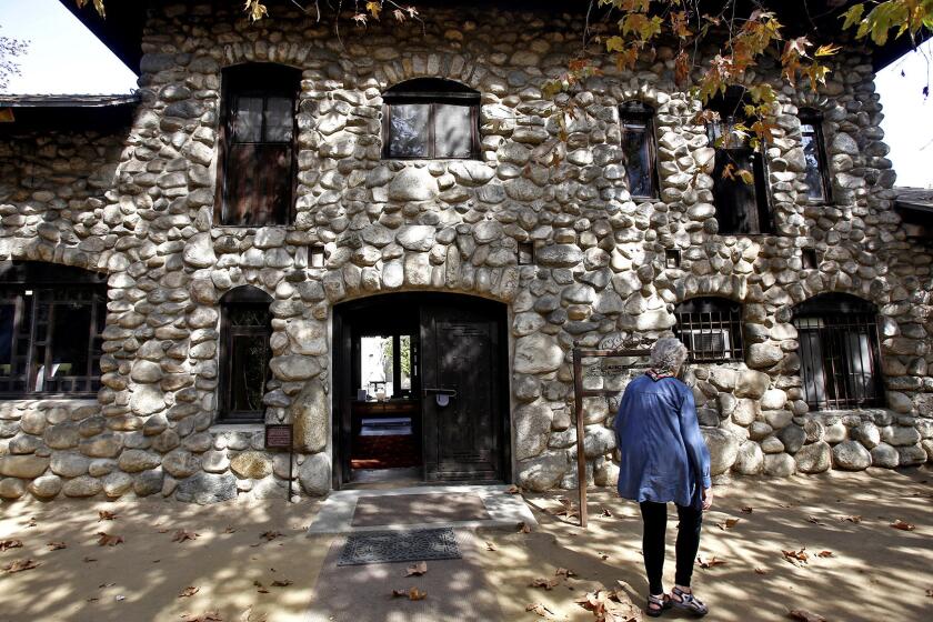 Executive Director Patricia Adler-Ingram of the Historical Society of Southern California walks outside the historic Lummis House.