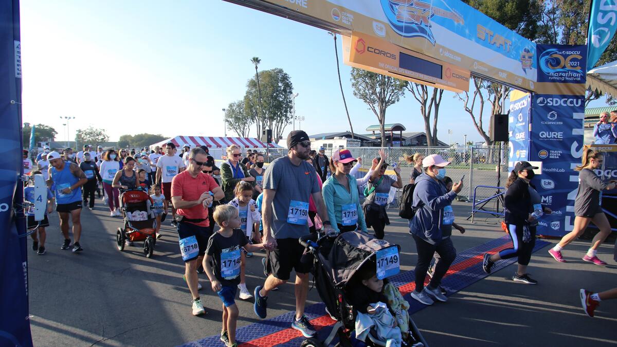 Families and walkers take part in the SDCCU OC 5K Run/Walk at the Orange County Fair and Event Center in Costa Mesa, on Saturday, November 6, 2021. (Photo by James Carbone)