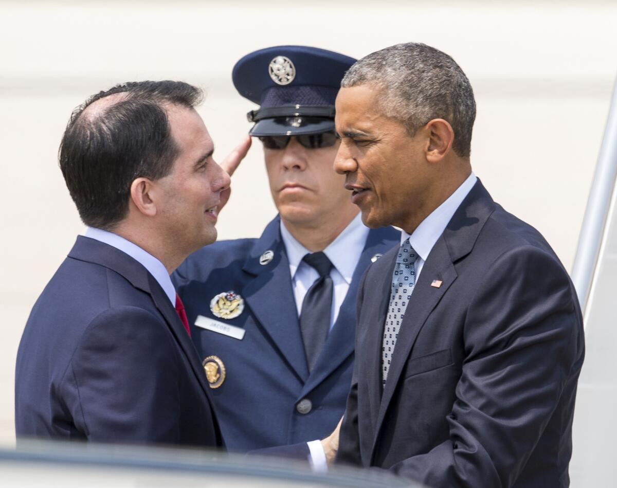 Wisconsin Gov. Scott Walker greets President Obama during a recent presidential visit to the state.