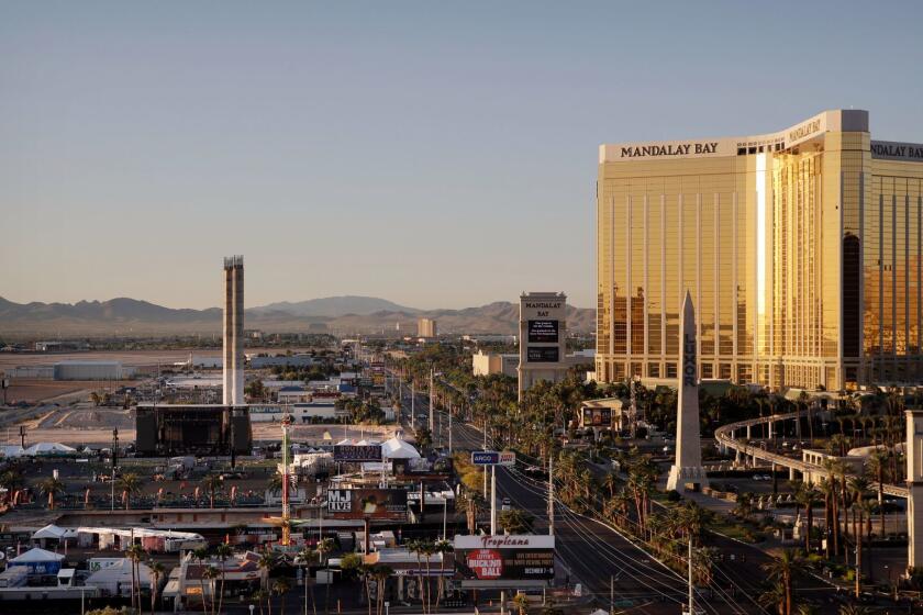 The Mandalay Bay resort and casino, right, overlooks an outdoor festival grounds across the street, left, Tuesday, Oct. 3, 2017, in Las Vegas. Authorities said Stephen Craig Paddock broke the windows on the casino and began firing with a cache of weapons, killing dozens and injuring hundreds at a music festival at the grounds. (AP Photo/John Locher)