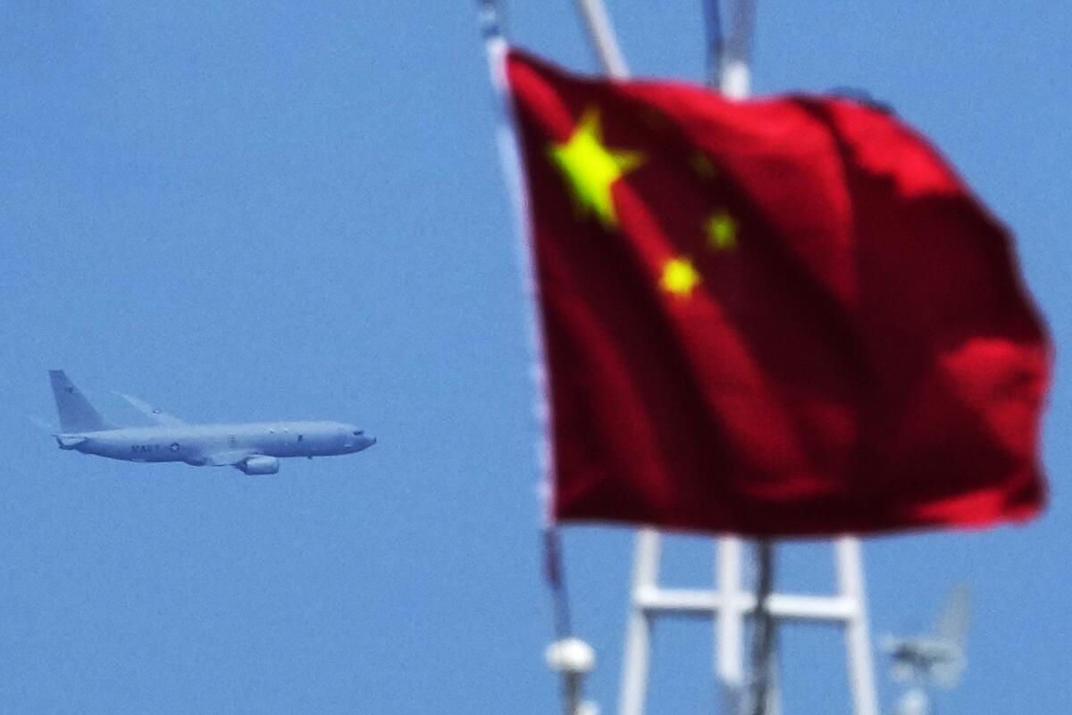 A plane is seen midair in the background with a Chinese flag in the foreground.