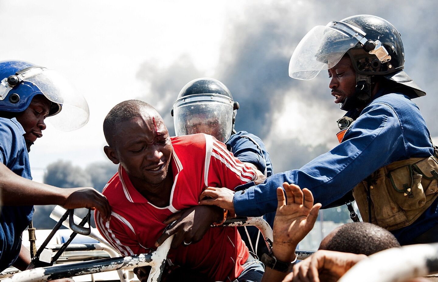 A man is lifted by police during a protest in Bujumbura. A top Burundian general announced the overthrow of President Pierre Nkurunziza, following weeks of violent protests against the president's bid to stand for a third term. Nkurunziza asserted he remained in charge.