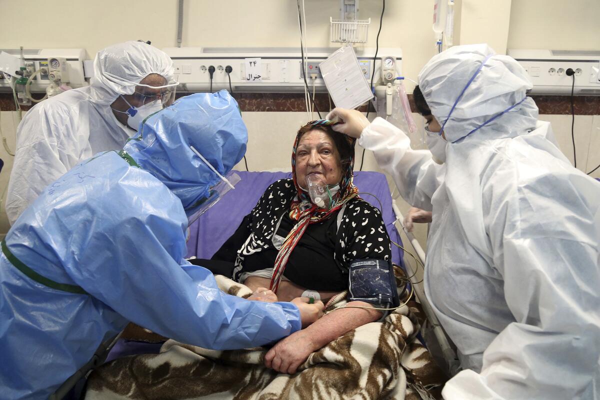 A patient infected with the coronavirus is treated at a hospital in Tehran last month. Nine out of 10 cases of the virus in the Middle East come from the Islamic Republic and fears remain that Iran may be underreporting its cases.