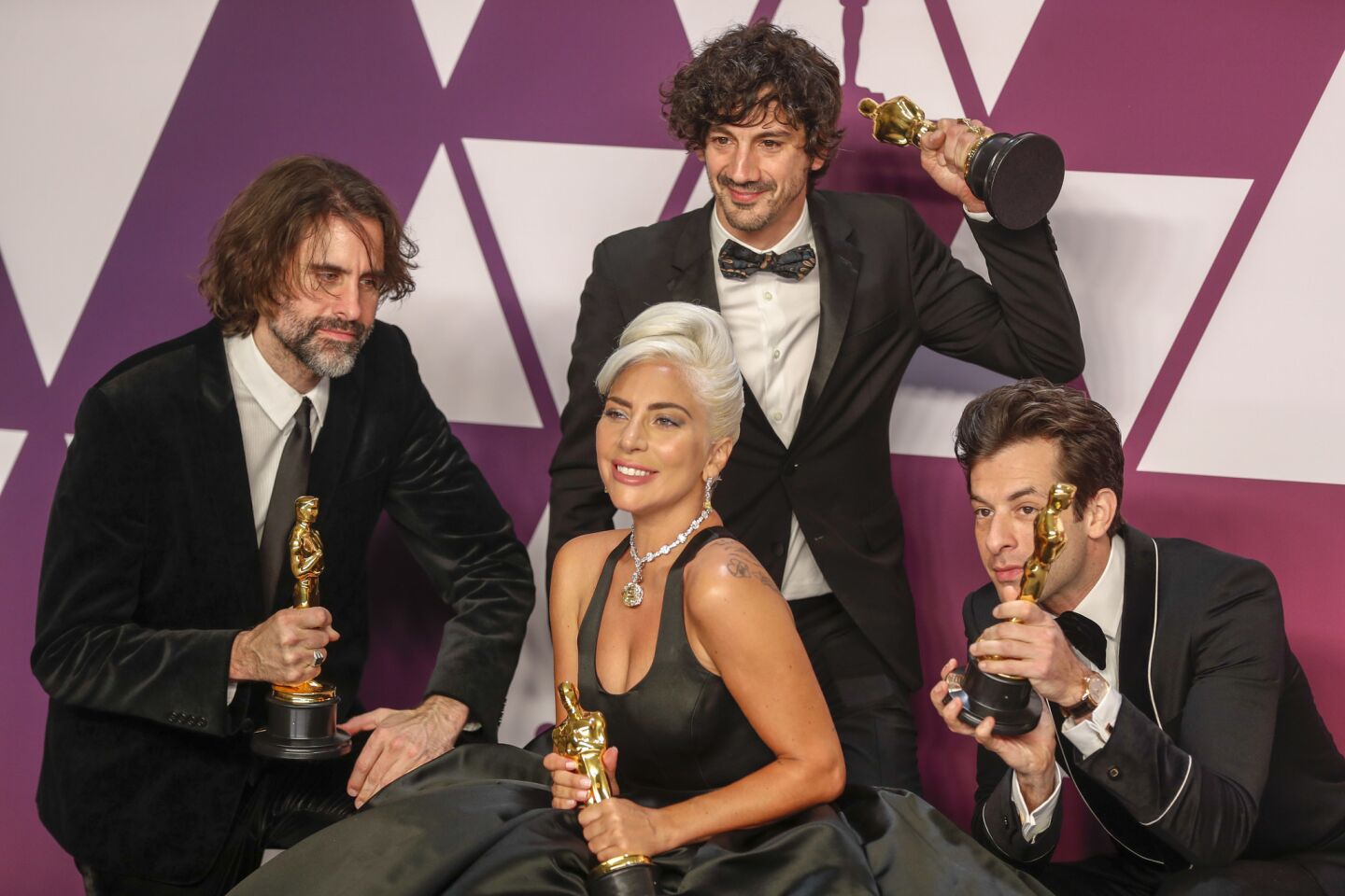 Andrew Wyatt, left, Anthony Rossomando, Lady Gaga and Mark Ronson pose with the original song award for "Shallow" from the film "A Star Is Born."