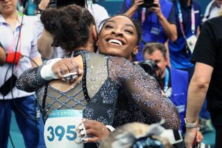 PARIS, FRANCE July 28, 2024-USA's Simone Biles, right hugs Hezly Rivera after qualifying.