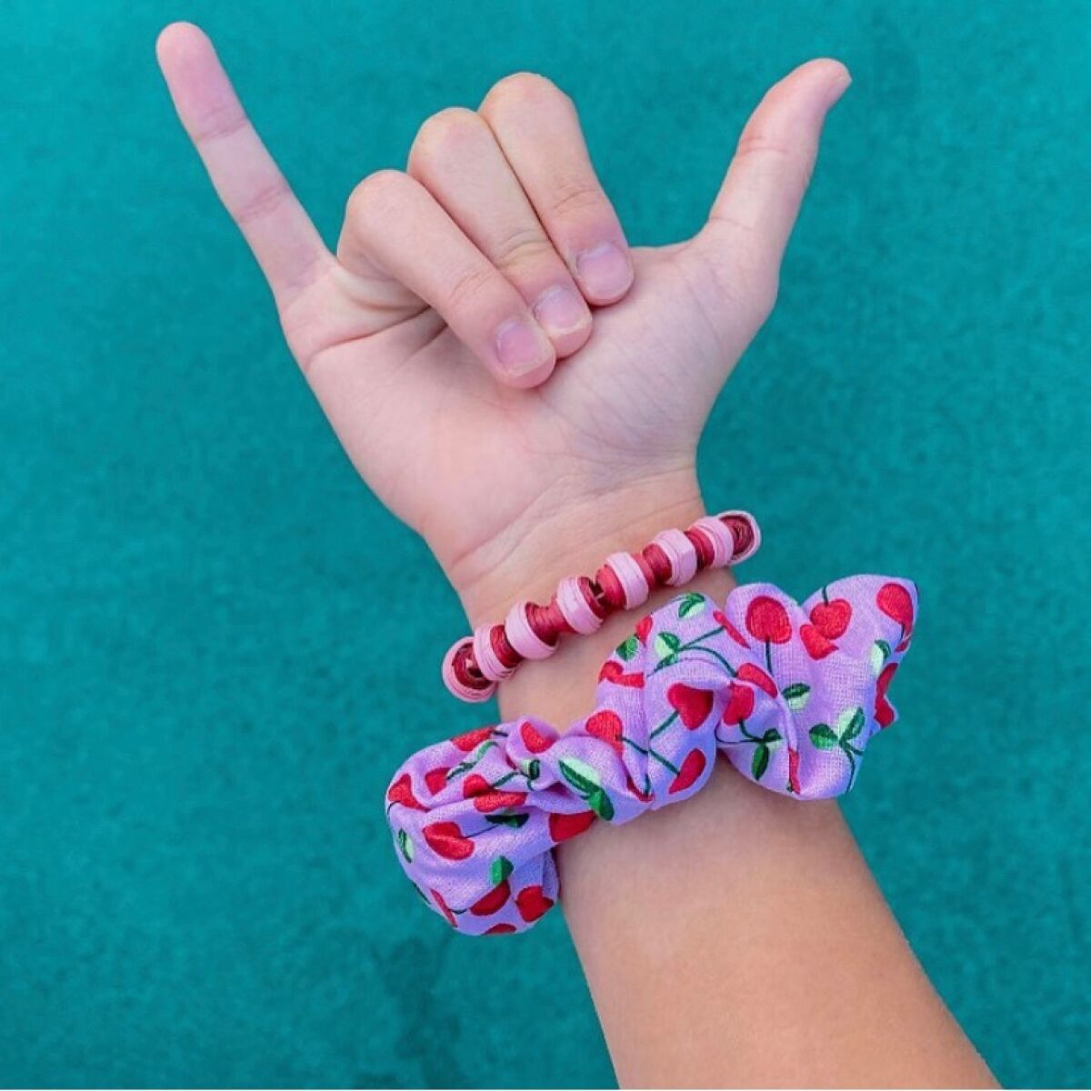 A beaded bracelet and a scrunchy are two of the items available from Pacific Paradiso.