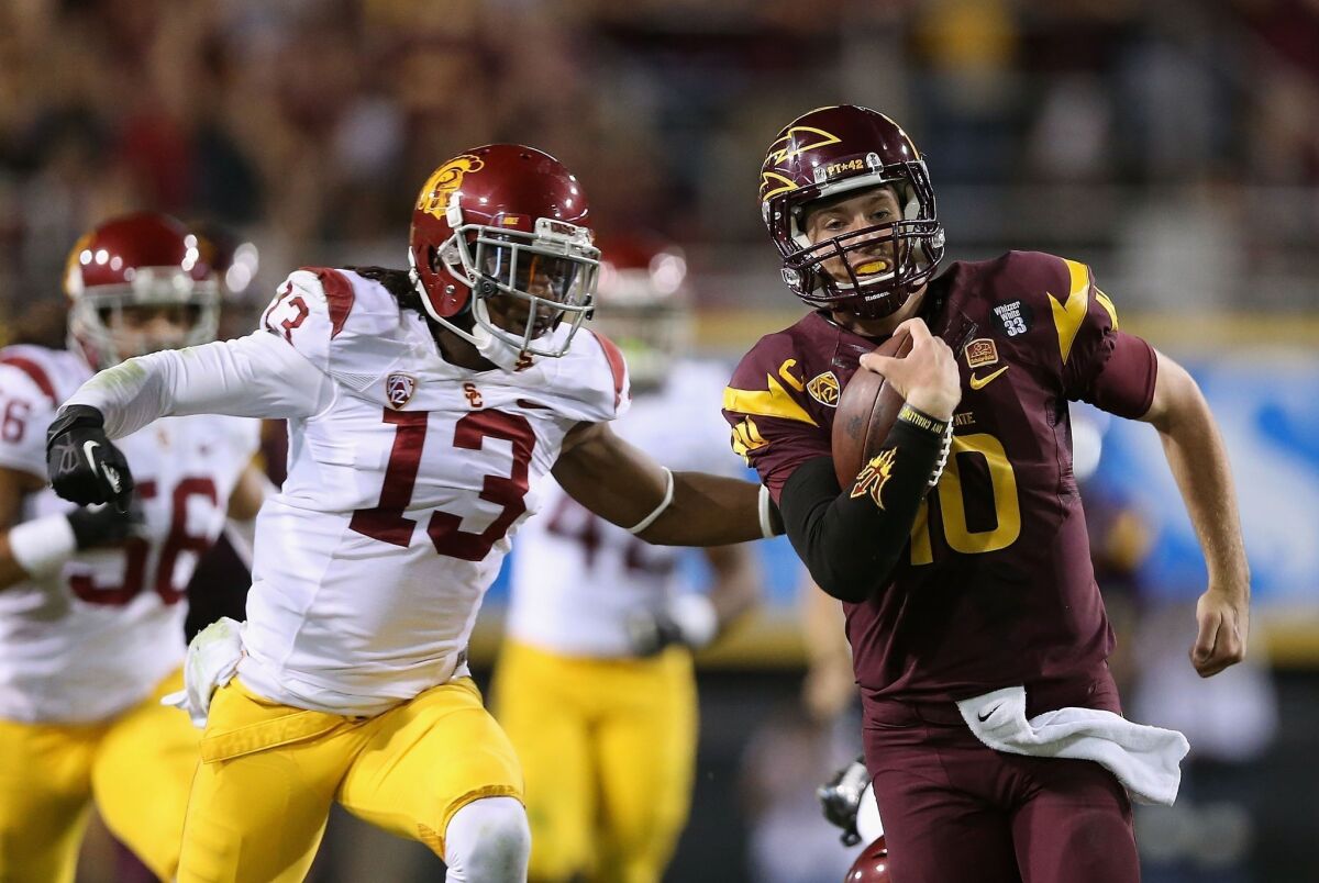 USC cornerback Kevon Seymour, left, chases down Arizona State quarterback Taylor Kelly during a game last month. Seymour expects to see plenty of passes thrown his way against Oregon State on Friday.