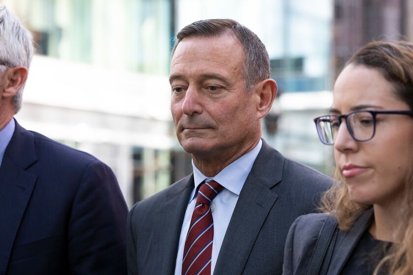 Former Pimco CEO Douglas Hodge, center, leaves the federal courthouse in Boston with his attorneys after pleading guilty for paying to have his children admitted to university as a fake athletic recruits in the college admissions scandal.