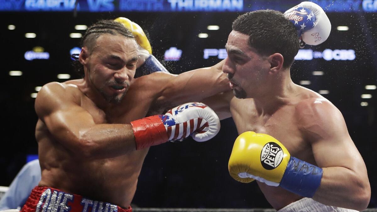 Keith Thurman, left, fights Danny Garcia during the fifth round of a welterweight championship boxing match in March 2017.