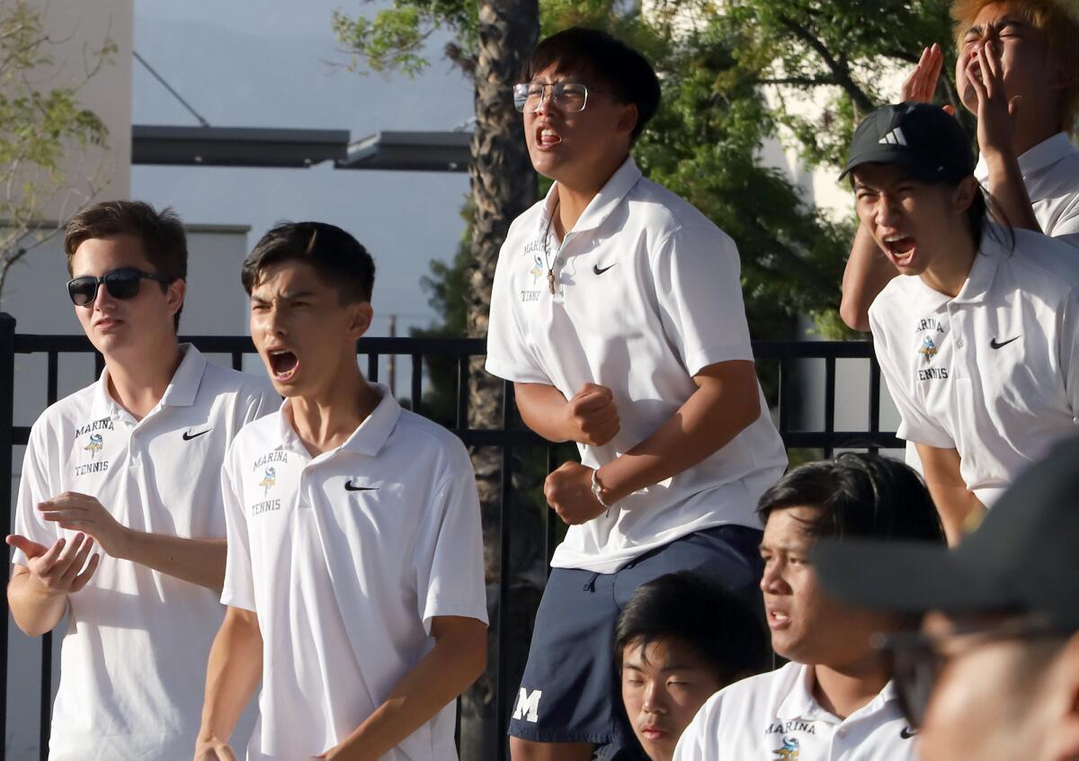 The Marina High School boys' tennis team cheers for teammates during Friday's match.
