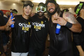 SAN DIEGO, CA - OCTOBER 2: San Diego PadresHa-Seong Kim, left, Jurickson Profar and Jorge Alfaro celebrate in the locker room after the team clinched a wildcard playoff spot at Petco Park on Sunday, October 2, 2022 in San Diego, CA. (K.C. Alfred / The San Diego Union-Tribune)