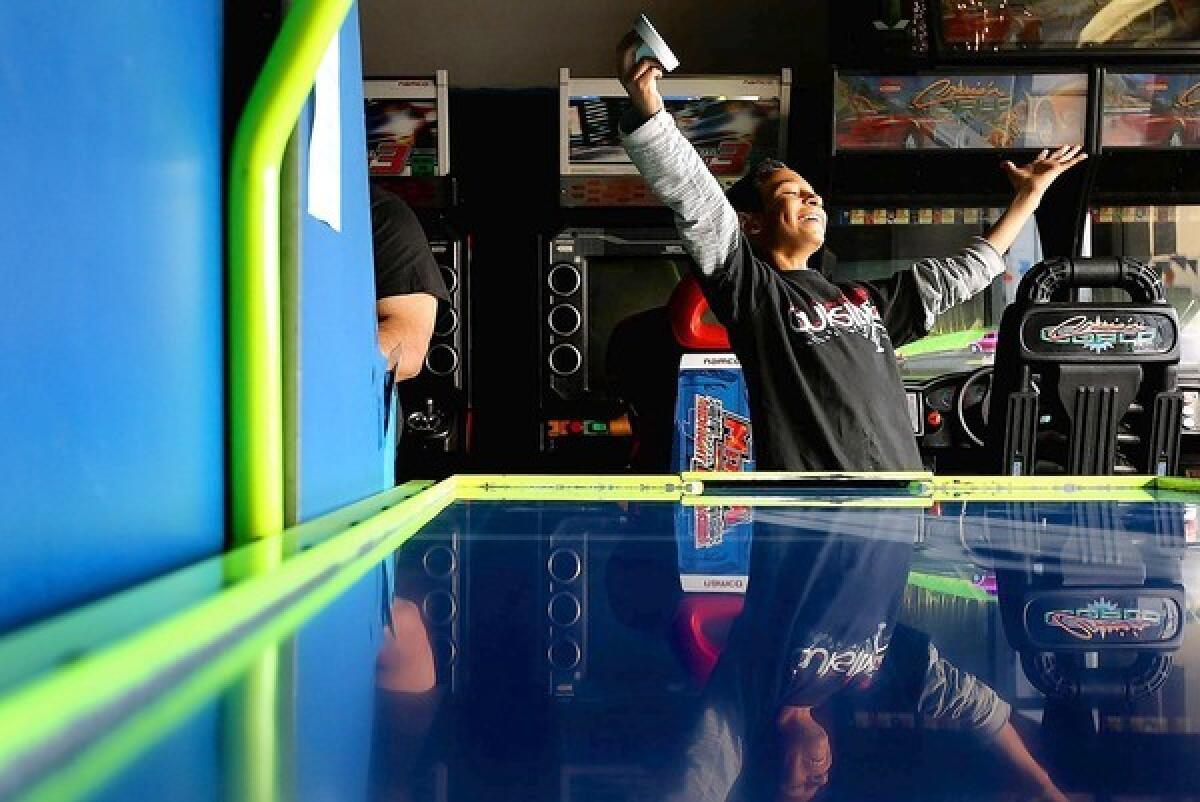 Andrew Peña, 11, of North Hills celebrates after winning a game of air hockey at Family Fun Arcade in Granada Hills.