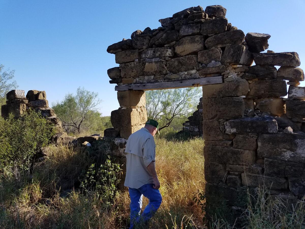 Mauricio Vidaurri walks among the ruins of a cabin where his father was born in 1925