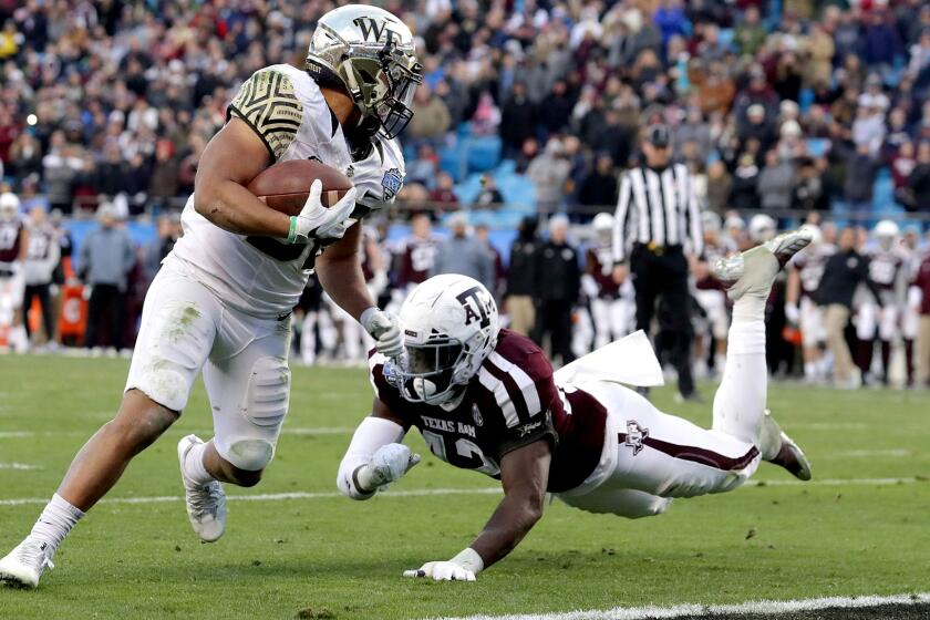 CHARLOTTE, NC - DECEMBER 29: Cade Carney #36 of the Wake Forest Demon Deacons scores the game winning touchdown against the Texas A&M Aggies during the Belk Bowl at Bank of America Stadium on December 29, 2017 in Charlotte, North Carolina. (Photo by Streeter Lecka/Getty Images) ** OUTS - ELSENT, FPG, CM - OUTS * NM, PH, VA if sourced by CT, LA or MoD **
