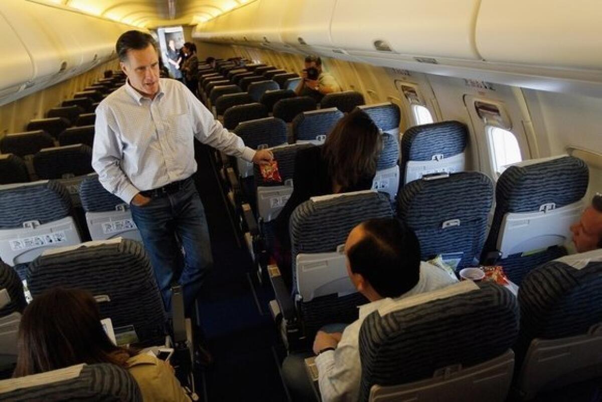 Mitt Romney talks to reporters on his plane at the Jacksonville International airport before flying to St. Petersburg, Fla.. on Monday.
