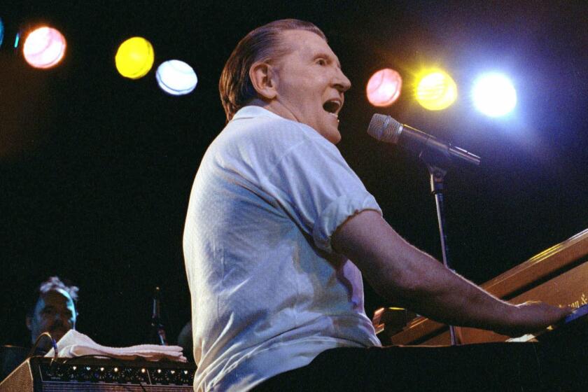FILE--Jerry Lee Lewis performs at the Camel Rock Casino in Tesuque, N.M., May 27, 2000. Three cousins from a Mississippi Delta town spent their childhood together, peeking into blues clubs, pounding out piano tunes and creating their own rock 'n' roll before the music even had a name. Jimmy Swaggart, Mickey Gilley and Lewis took dramatically different paths in their careers. The three cousins are to reunite for the first time in a decade on Saturday when they will be inducted into the Delta Music Museum Hall of Fame in Ferriday,La. (AP Photo/Sarah Martone, File)