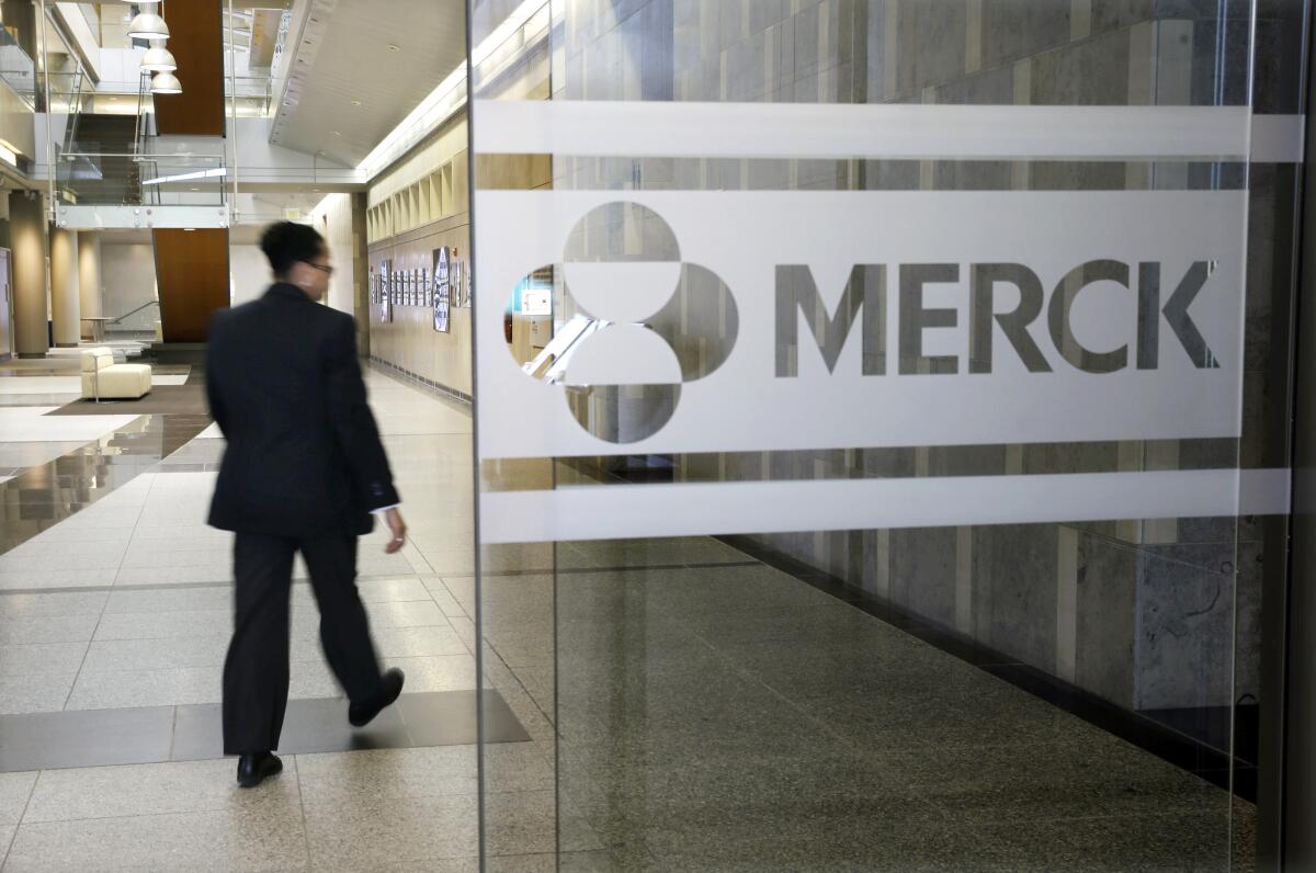 The Merck logo on a glass wall 